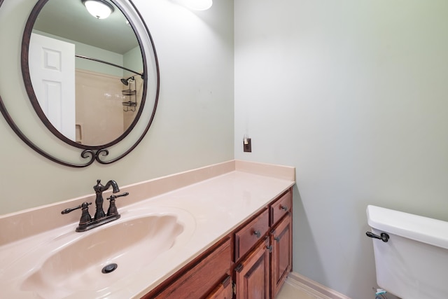 bathroom featuring walk in shower, vanity, and toilet