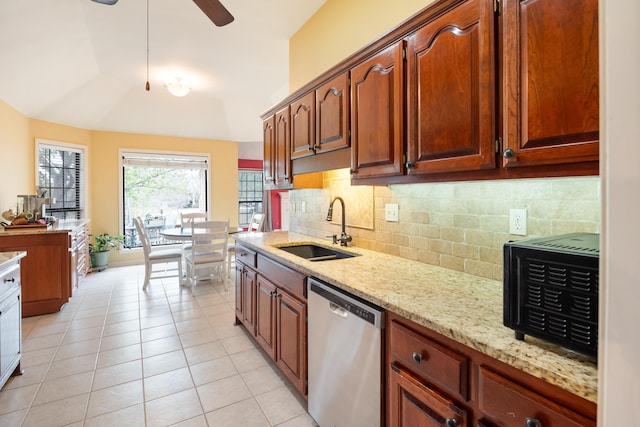 kitchen featuring dishwasher, lofted ceiling, backsplash, sink, and light tile patterned floors