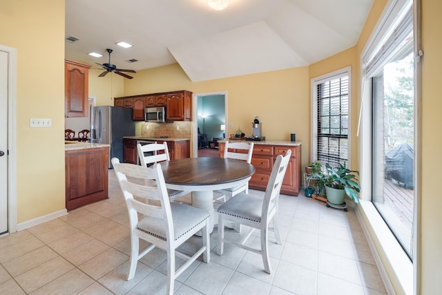 dining room featuring ceiling fan, a healthy amount of sunlight, and light tile patterned floors