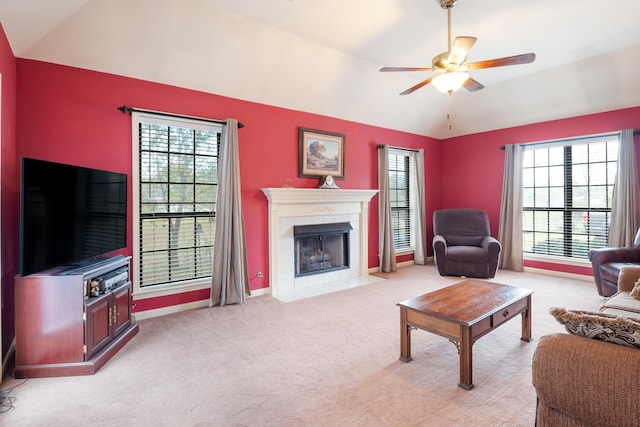 living room featuring light colored carpet, a healthy amount of sunlight, and lofted ceiling