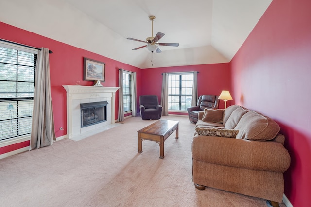 carpeted living room featuring a tile fireplace, ceiling fan, and vaulted ceiling