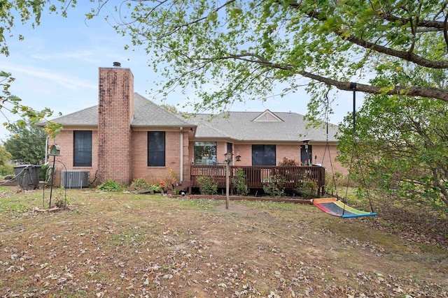 back of house featuring cooling unit and a wooden deck