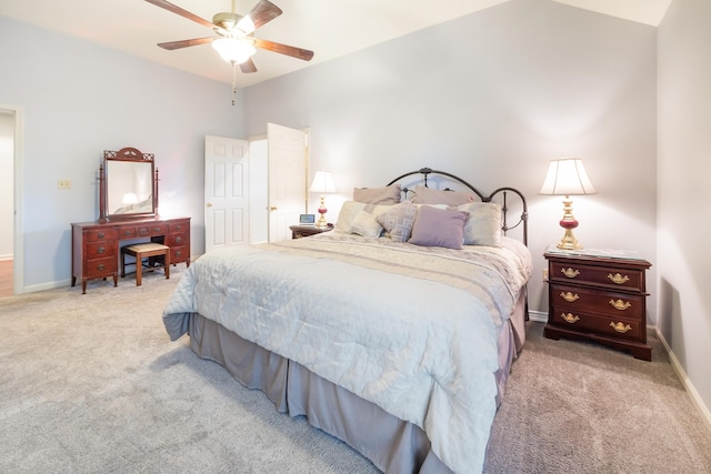 carpeted bedroom featuring ceiling fan and vaulted ceiling