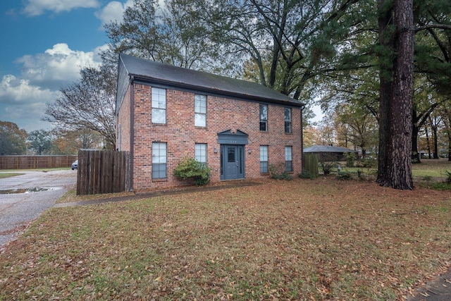 colonial inspired home with a front lawn