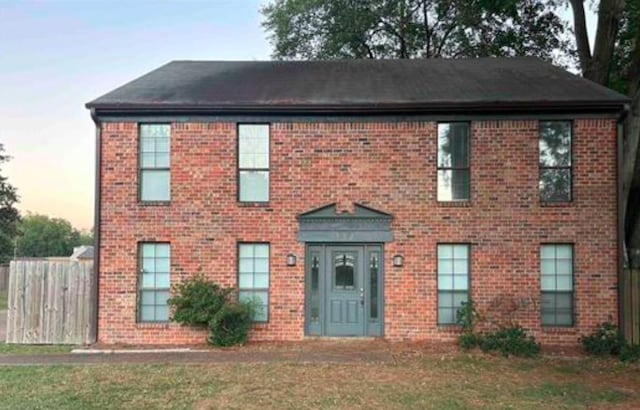 colonial inspired home with a lawn