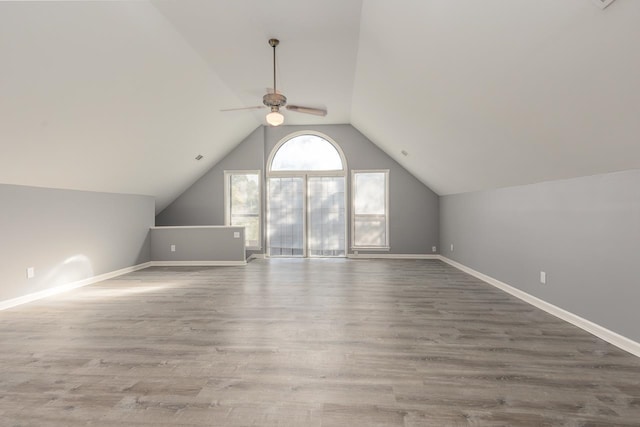 bonus room featuring ceiling fan, hardwood / wood-style floors, and vaulted ceiling