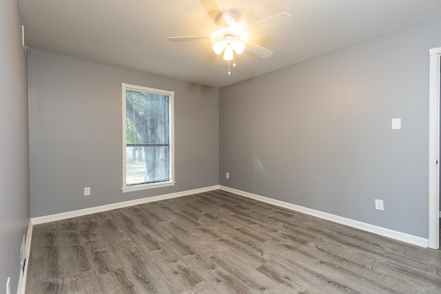 spare room with ceiling fan and wood-type flooring