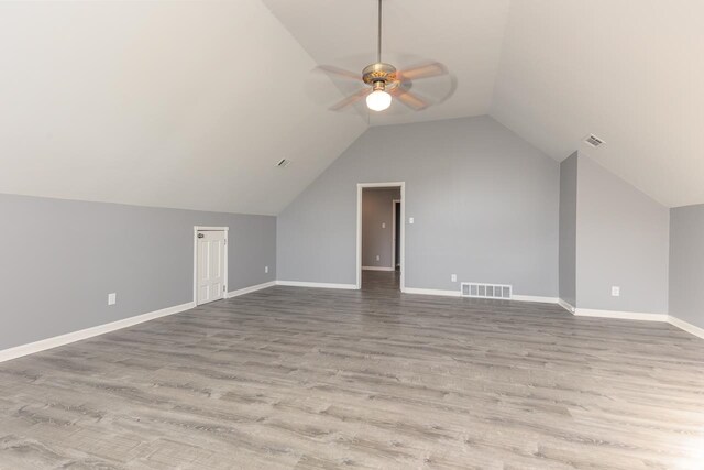 bonus room with ceiling fan, lofted ceiling, and light wood-type flooring