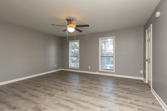 spare room with ceiling fan and light hardwood / wood-style floors