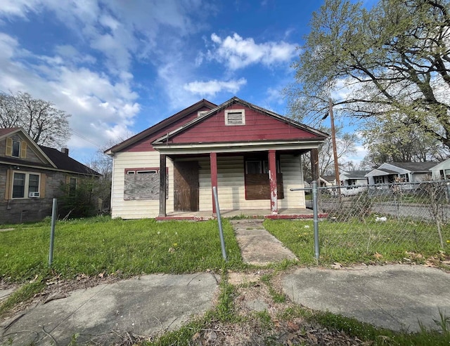 bungalow with a porch and a front yard