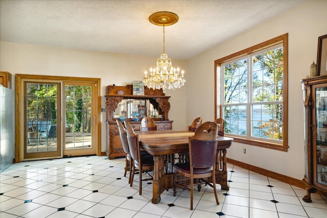 dining space featuring a textured ceiling, a notable chandelier, and light tile patterned floors