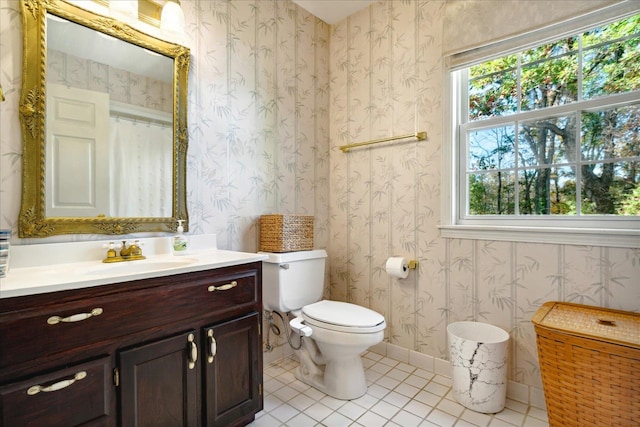 bathroom with walk in shower, tile patterned flooring, vanity, and toilet