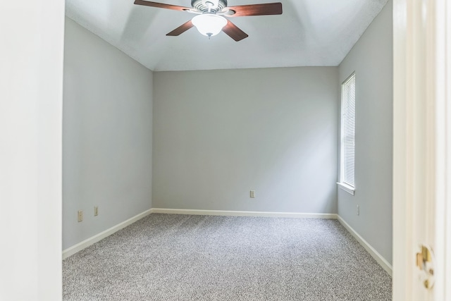 carpeted spare room featuring ceiling fan