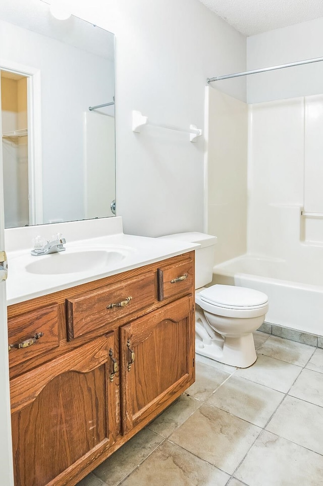 full bathroom featuring tile patterned floors, vanity, a textured ceiling, bathtub / shower combination, and toilet