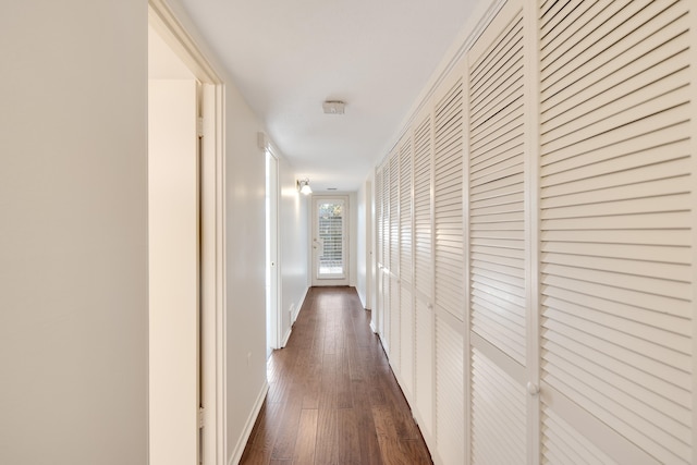 hallway with dark wood-type flooring