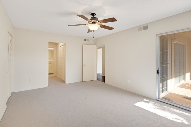 unfurnished bedroom with a closet, access to outside, ensuite bath, light carpet, and ceiling fan