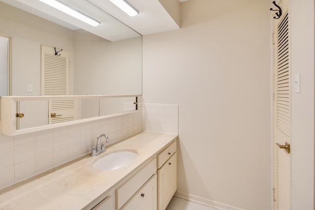 bathroom featuring tasteful backsplash, vanity, and tile patterned floors