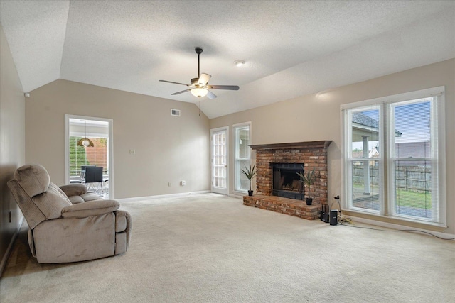 living room with lofted ceiling, carpet flooring, ceiling fan, and a fireplace