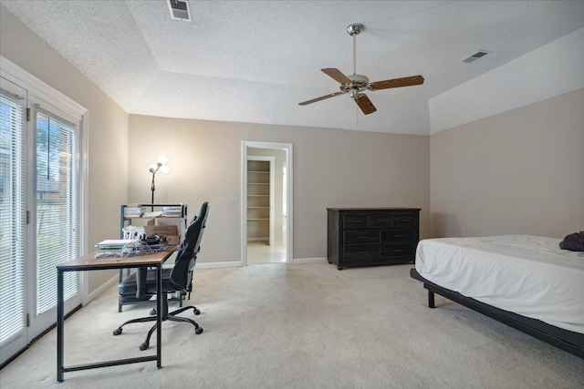 bedroom with ceiling fan, a textured ceiling, light carpet, and lofted ceiling