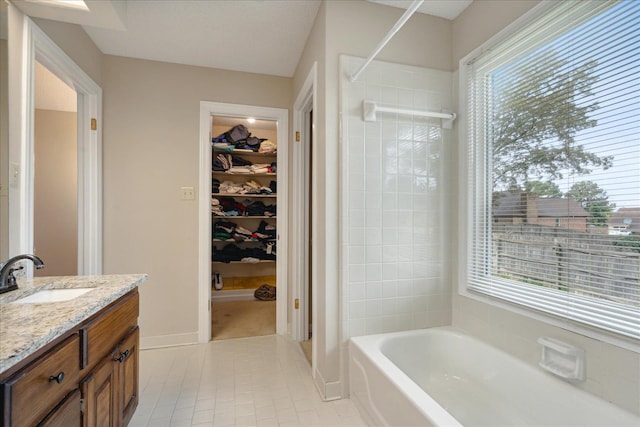 bathroom with vanity, a wealth of natural light, tile patterned floors, and shower with separate bathtub