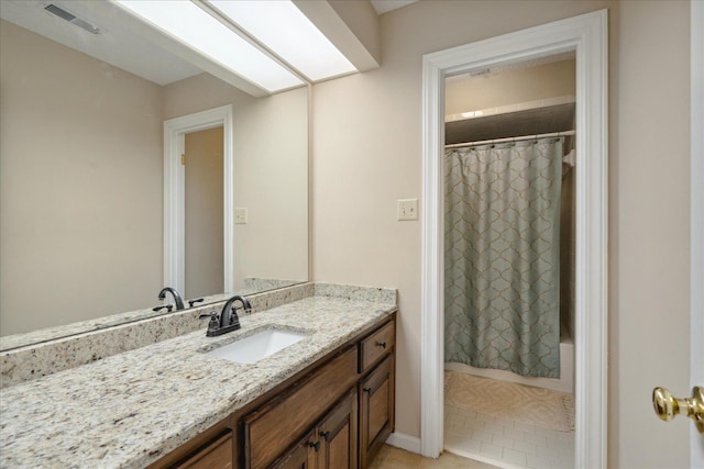 bathroom featuring shower / tub combo, vanity, and tile patterned floors