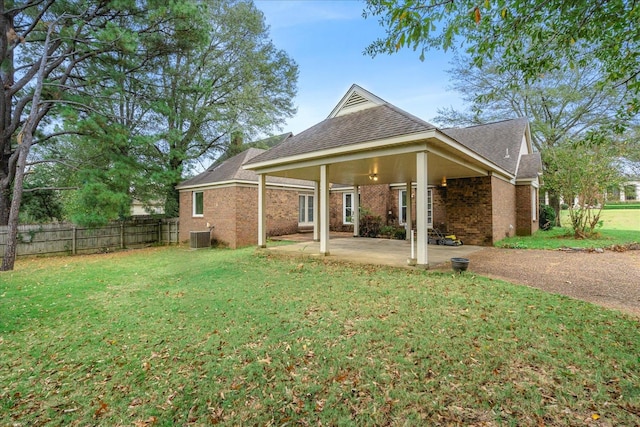 back of property with a patio and a yard