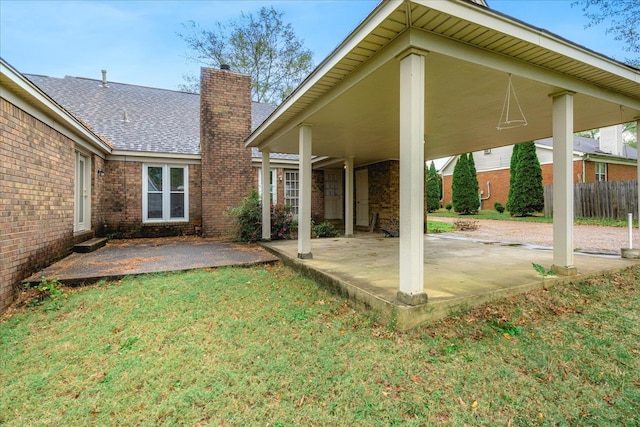 back of property featuring a yard and a patio area