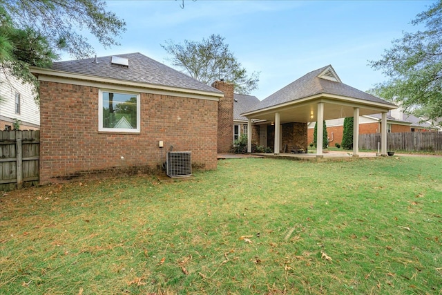 rear view of property featuring a patio, a lawn, and cooling unit