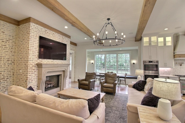 living room featuring beamed ceiling and a notable chandelier