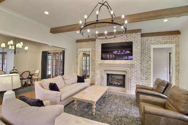 living room with wood-type flooring, a fireplace, crown molding, beam ceiling, and a chandelier