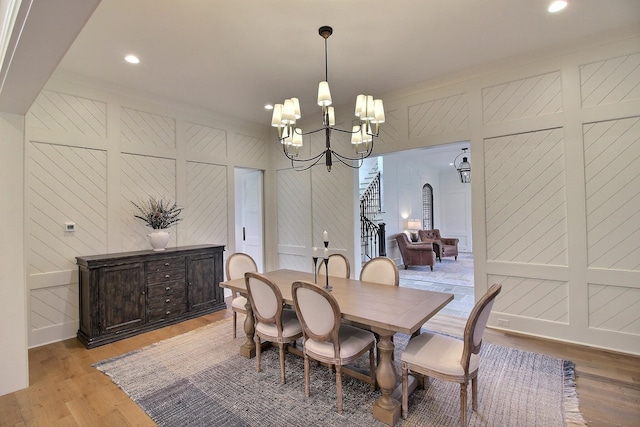 dining area featuring wood walls and light hardwood / wood-style floors