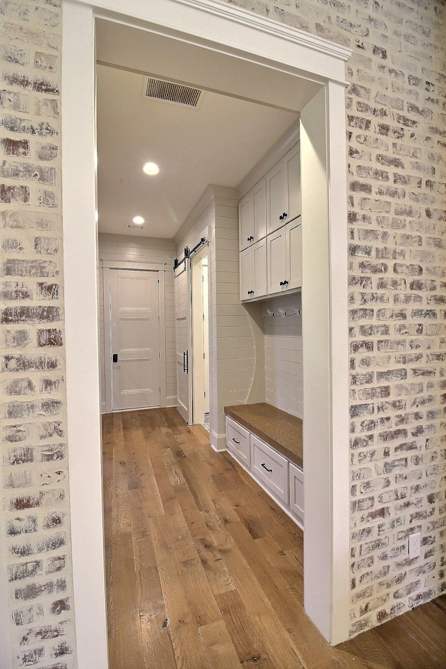 mudroom featuring light hardwood / wood-style floors and a barn door