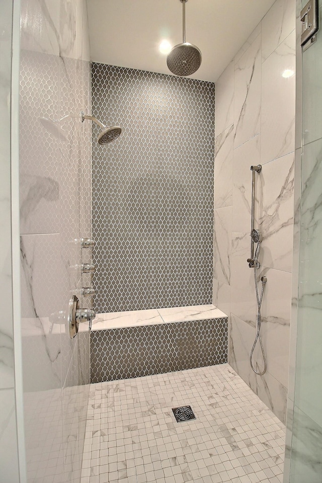 bathroom with a tile shower