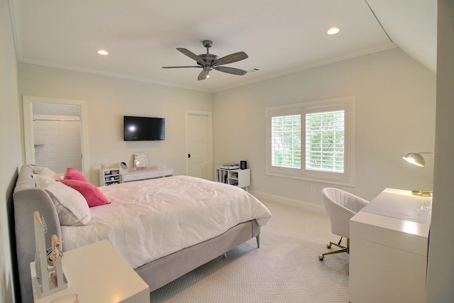 carpeted bedroom featuring ceiling fan and crown molding