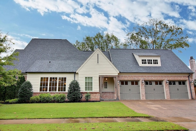 view of front facade with a front yard and a garage