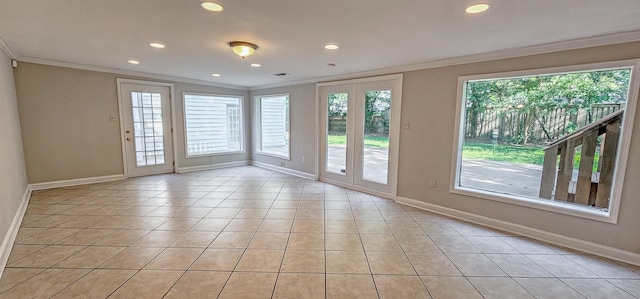 entryway with light tile patterned flooring and crown molding