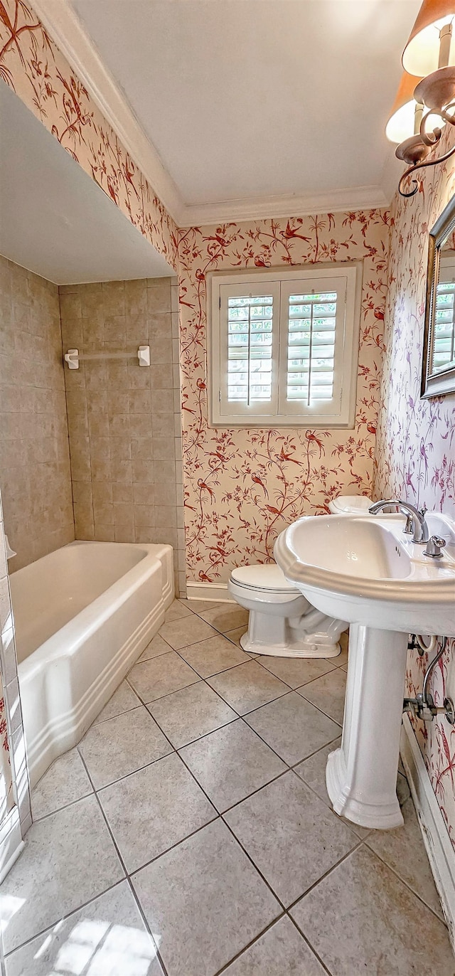 bathroom featuring toilet, a bathtub, ornamental molding, and tile patterned floors