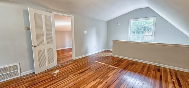 bonus room featuring lofted ceiling and hardwood / wood-style flooring