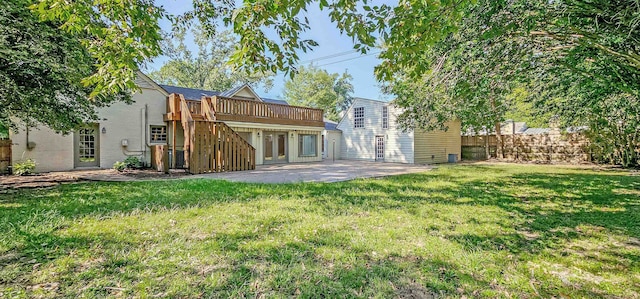 back of house with a patio, a yard, and a wooden deck