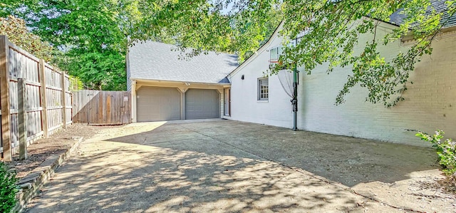 view of side of home with a garage