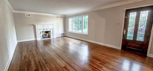 unfurnished living room featuring dark wood-type flooring, crown molding, and a fireplace