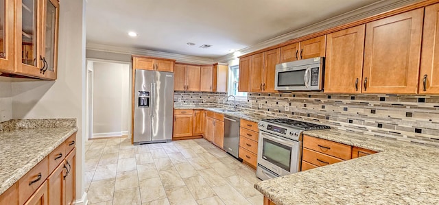 kitchen featuring decorative backsplash, sink, light stone counters, and appliances with stainless steel finishes