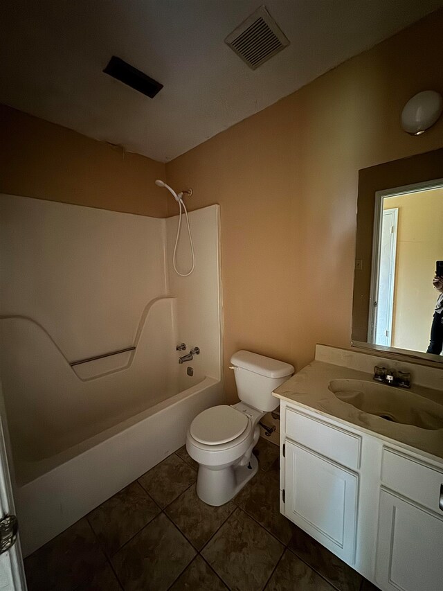 full bathroom with toilet, vanity, tile patterned floors, and  shower combination