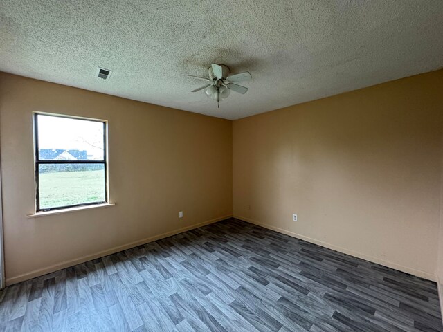 empty room featuring wood-type flooring, ceiling fan, and a textured ceiling