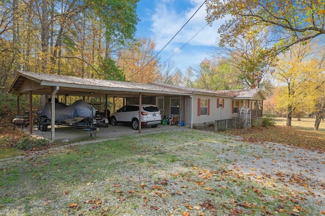 exterior space featuring a yard and a carport