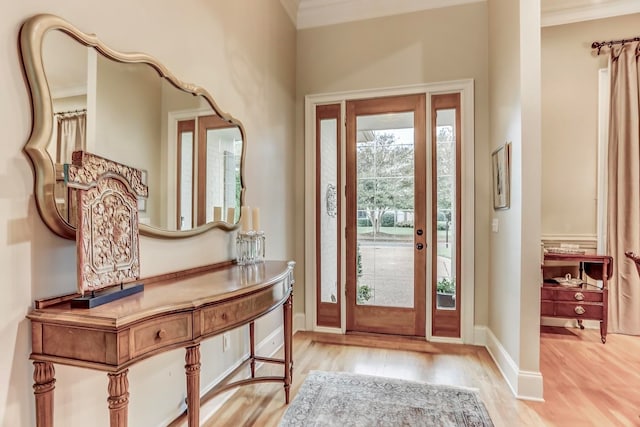 foyer entrance featuring ornamental molding and light hardwood / wood-style floors