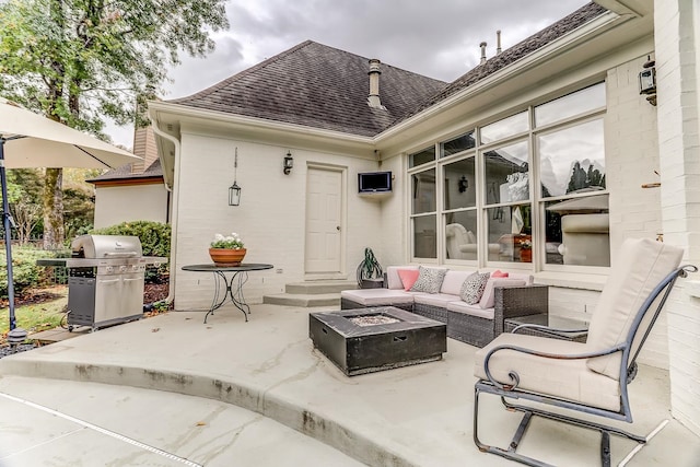 view of patio / terrace featuring an outdoor living space with a fire pit and grilling area