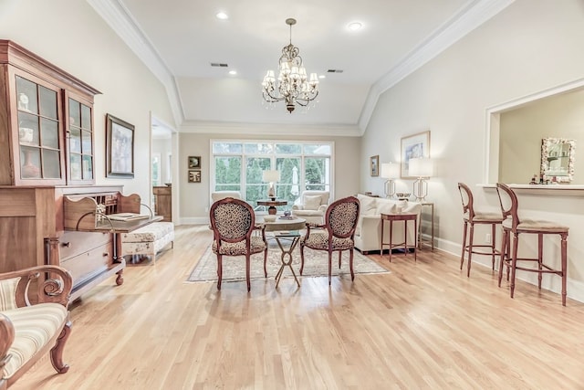 sitting room with vaulted ceiling, a notable chandelier, ornamental molding, and light hardwood / wood-style flooring