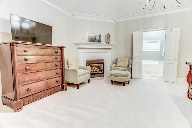 sitting room featuring a tiled fireplace, carpet flooring, and crown molding