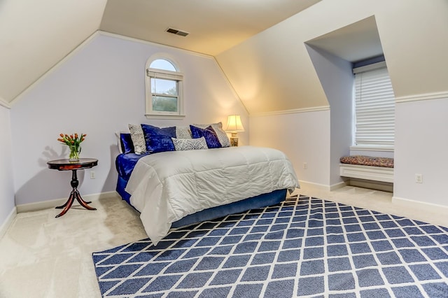 carpeted bedroom with vaulted ceiling